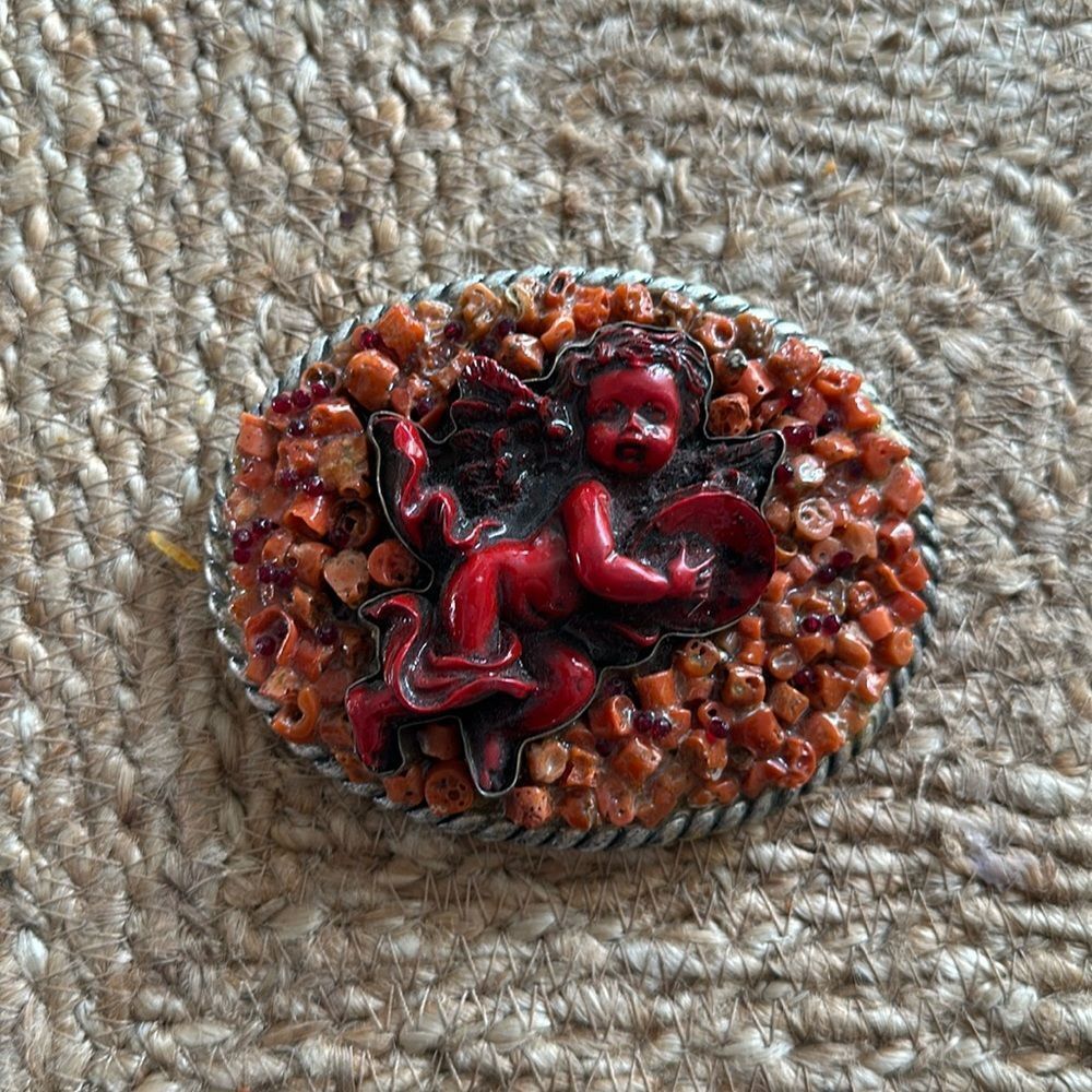 Handmade Coral Cherub belt buckle. One-of-a-kind.